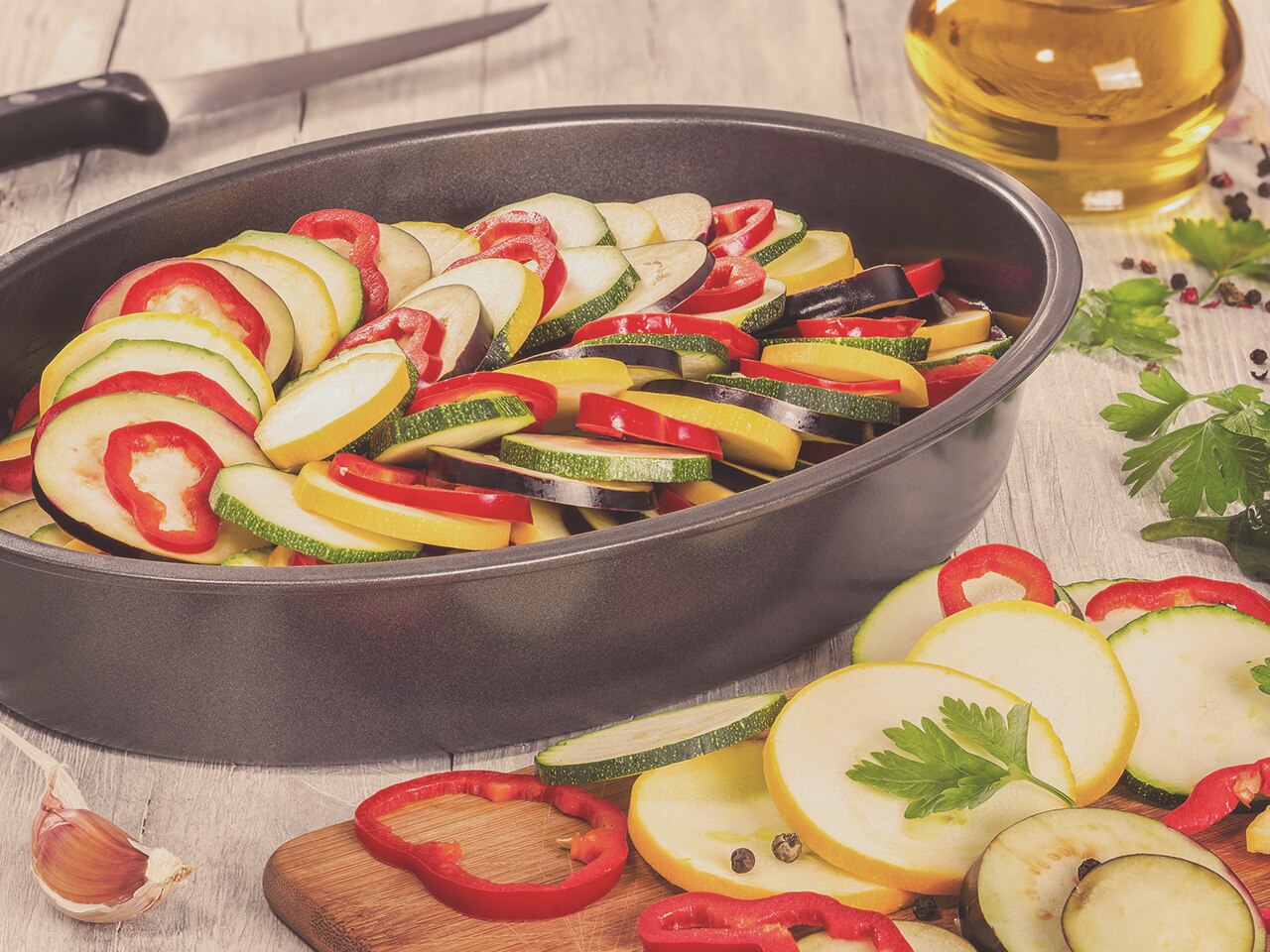 A table with vegetables inside a cooking pot